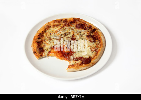 Partly eaten Pepperoni Pizza on a white background Stock Photo
