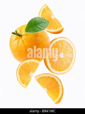 Falling orange and orange slices. Isolated on a white background. Stock Photo