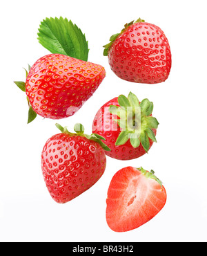 Falling strawberries. Isolated on a white background. Stock Photo