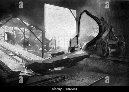 This early 1900s photo shows an Inland Steel company worker with the pig iron casting machine. Stock Photo