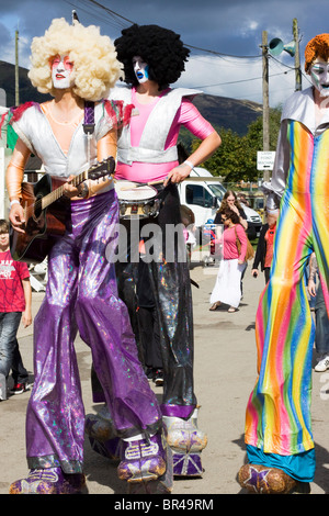 Men on stilts dressed as Rockers Stock Photo