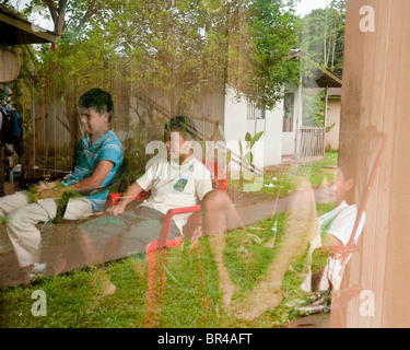 Maleku's children, looking television, Costa Rica. Stock Photo