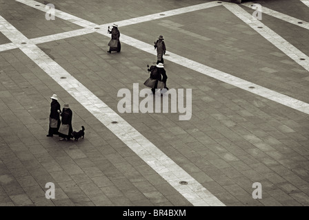 Tibetan Pilgrims cross Beijing Street on their way to the Potala Palace in Lhasa, Tibet Autonomous Region, China. Stock Photo