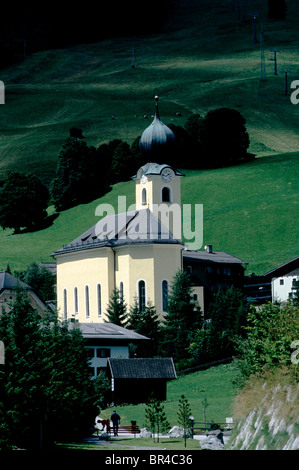Bernkogel church with its characteristic onion dome located on the outskirts of Hinterglemm in the Austrian Alps. Stock Photo