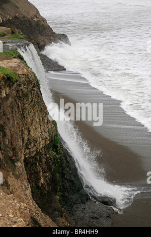 ALAMERE FALLS and PACIFIC OCEAN WAVES on a black sand beach on the COAST TRAIL - POINT REYES NATIONAL SEASHORE, CALIFORNIA Stock Photo