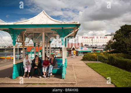 UK, England, Merseyside, Southport, Lower Promenade, women sitting in shelter beside Marine Lake Stock Photo