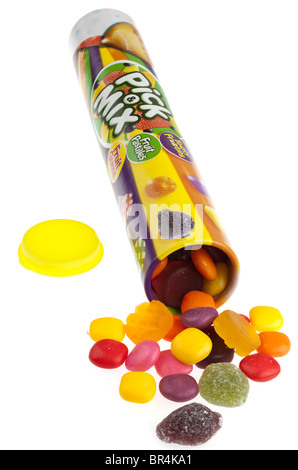 Tall tube of Rowntrees Pick and Mix sweets spilling onto a white surface Stock Photo