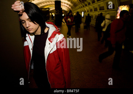 A young woman takes a break at the Metro Center metro stop in Washington, DC on December 19, 2008. Stock Photo