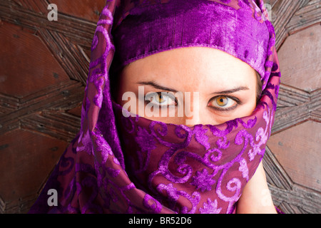 woman dressed in saharaui costume, old wood gate background Stock Photo