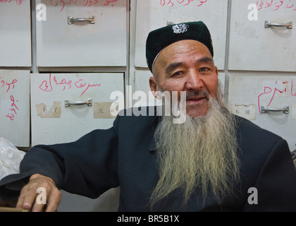 Portrait of an old Uygur man with beard and felt hat in Xinjiang China ...