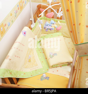 Baby cot in nursery Stock Photo