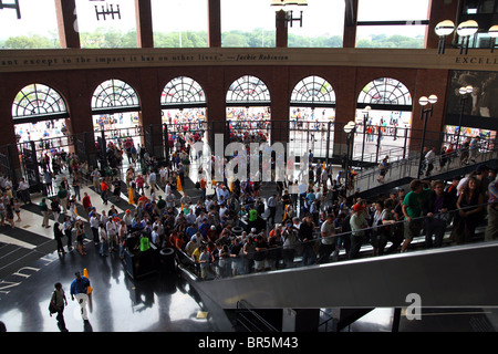 Fans riding up the escalator in the Jackie Robinson Rotunda at Citi Field, Queens, NY, USA Stock Photo