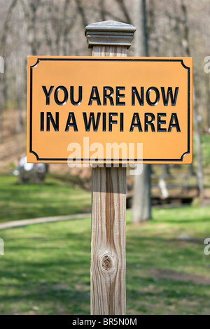 A sign that reads YOU ARE NOW IN A WIFI AREA indicating a wireless hotspot for internet use. Stock Photo