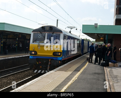 A class 92 electric locomotive operated by Eddie Stobart hauling a freight train through Wigan North Western station Stock Photo