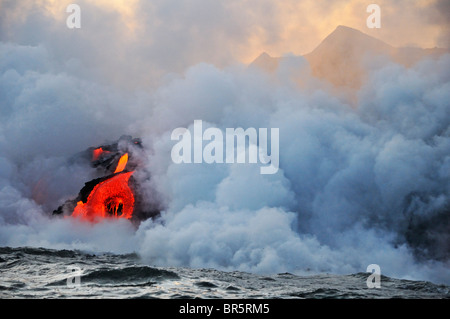 Steam rising off lava flowing into ocean, Kilauea Volcano, Hawaii Islands, United States Stock Photo