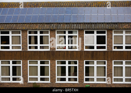 Solar PV Photo Voltaic panels on the roof of Ringmer community college. Stock Photo