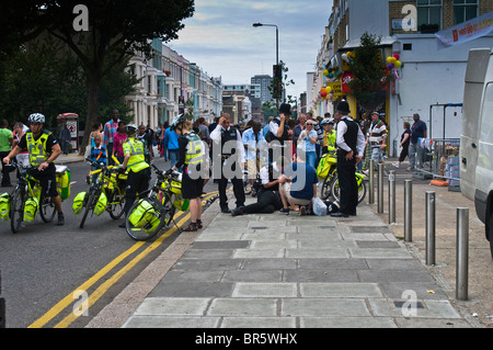 Police and Paramedics attend to someone who has collapsed at the 2009 Notting Hill Carnival Stock Photo