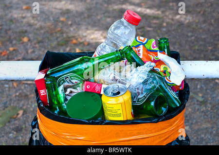 Waste basket full of rubbish, bottles and cans - France. Stock Photo