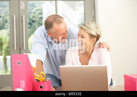 Couple Using Laptop At Home Stock Photo