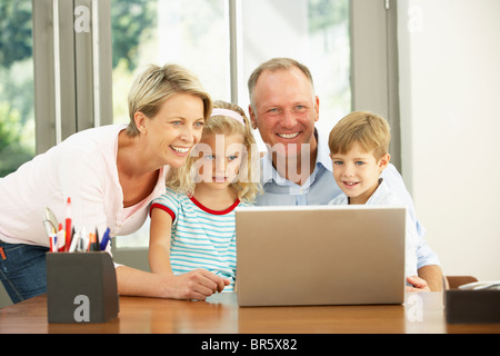 Family Using Laptop At Home Stock Photo