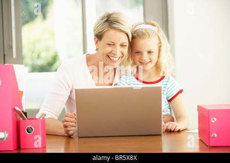 Mother And Daughter Using Laptop At Home Stock Photo
