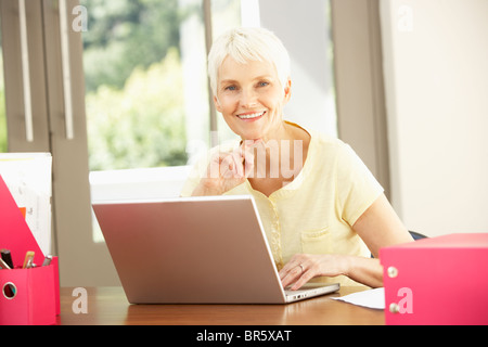 Senior Woman Using Laptop At Home Stock Photo