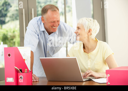 Adult Son And Senior Mother Using Laptop At Home Stock Photo