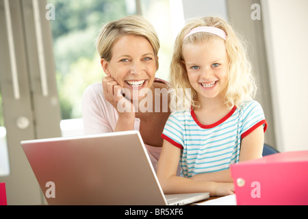 Mother And Daughter Using Laptop At Home Stock Photo