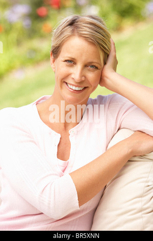 Young Woman Relaxing In Garden Stock Photo