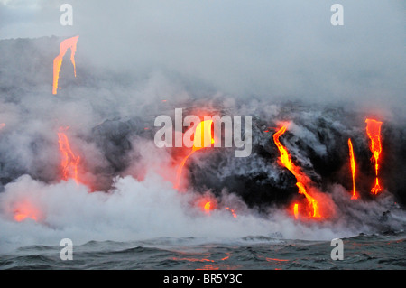 Steam rising off lava flowing into ocean, Kilauea Volcano, Hawaii Islands, United States Stock Photo