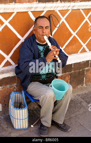 Blind man playing a recorder in the city of Puebla, Mexico. Stock Photo