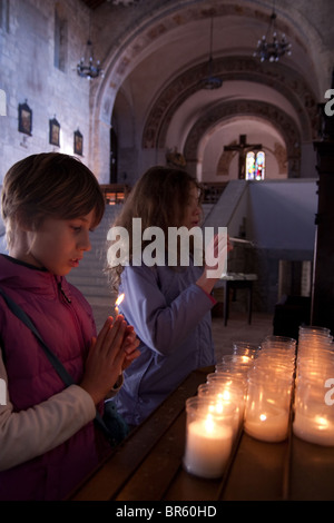 young girls praying in church in Italy Stock Photo