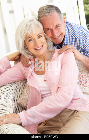 Portrait Of Senior Couple Relaxing Together On Sofa Stock Photo