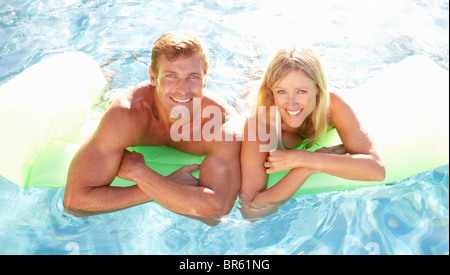 Couple Outside Relaxing In Swimming Pool Stock Photo