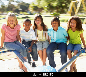 Group Of Children Riding On Roundabout In Playground Stock Photo