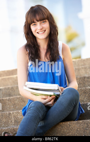 Teenage Student Sitting Outside On College Steps Stock Photo