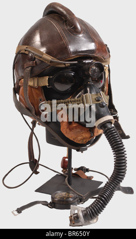 A Luftwaffe fighter pilot in the Reich's air defense., A model SSK 90 pilot's steel helmet. Skull of riveted steel plates with brown leather cover and cylindrical head pad, sand-coloured mottled cotton lining, complete with straps. A LKp S101 sand-coloured, linen flying helmet with brown leather trim, three- historic, historical, 1910s, 20th century, Second World War / WWII, object, objects, clipping, cut out, cut-out, cut-outs, stills, military, militaria, Luftwaffe, German Air Force, branch of service, branches of service, armed service, armed services, utens, Stock Photo