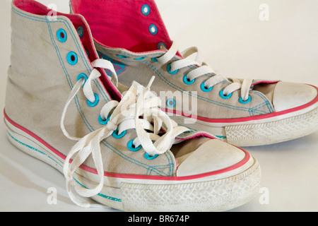 A pair of old, used, high-topped Converse sneakers or tennis shoes. Stock Photo