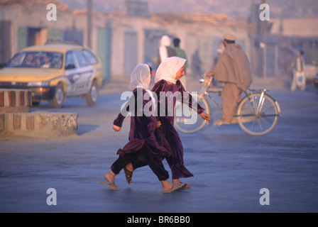 school girls cross a street in Kabul Afghanistan Stock Photo
