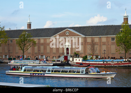 Canal tour boat in front of the Hermitage Museum on the River Amstel, Amsterdam, Holland Stock Photo