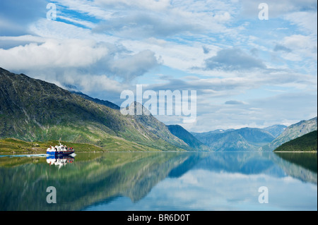 Passenger ferry boat travel from Gjendesheim towards Memurubu on Lake Gjende, Jotunheimen national park, Norway Stock Photo