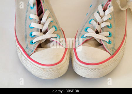 A pair of old, used, high-topped Converse sneakers or tennis shoes. Stock Photo