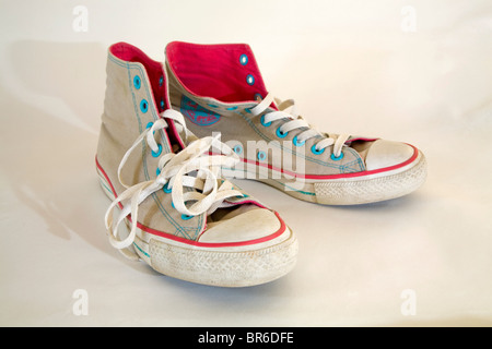 A pair of old, used, high-topped Converse sneakers or tennis shoes. Stock Photo