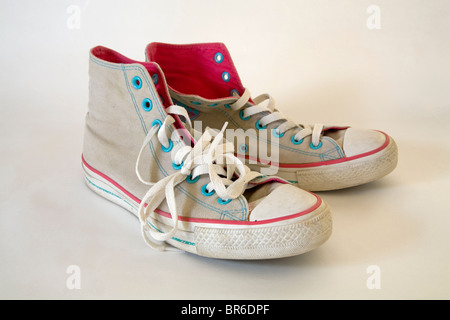 A pair of old, used, high-topped Converse sneakers or tennis shoes. Stock Photo