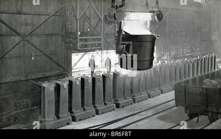 This early 1900s photo shows an Inland Steel company workers at the process of pouring the ingots. Stock Photo