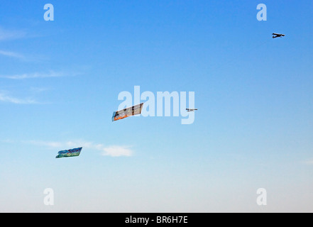 Airplane towing advertising banner over beach at Long ...