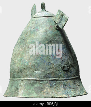 A Hellenistic Pilos type helmet, 4th century B.C. Bronze helmet with a tall conical skull. The flaring rim bordered by two raised bands. Pairs of holes on either side with soldered, pierced disk appliqués bearing wheel decoration. The crest reinforced by a cap with chase decorated edge (ancient repair?) topped by a riveted crest holder. Fragments of two riveted horn attachments on either side. Height 23.5 cm, weight 798 g. Blue-green patina with soil occlusions. The skull glued and supplemented. The inside reinforced with fibreglass. Slightly deformed, intensel, Stock Photo