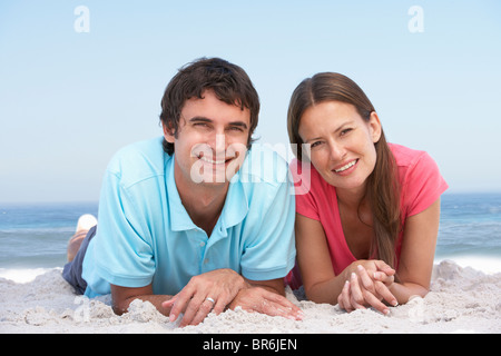 Young Couple Relaxing On Beach Stock Photo