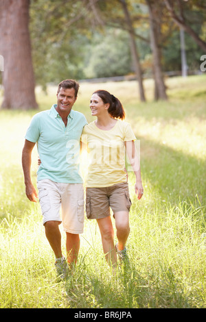 Portrait Of Young Couple Walking In Park Stock Photo