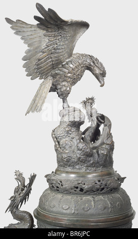 A Japanese floor vase, 19th century. Patinated bronze cast in several pieces. Three-dimensionally worked lid displaying a Phoenix and a dragon. Ornamented bellied corpus sectioned into four fields bearing plants and birds in relief. Inserted handles shaped as dragons on each side (one leg of a dragon broken but included). Tall, detachable base in relief with surrounding depictions of dragons with fully plastic heads (one head included but loose, one fixed with screws). Another three-dimensional dragon winds itself between corpus and base. Small defects, repairs, Stock Photo